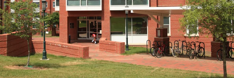A person shown accessing their room on campus