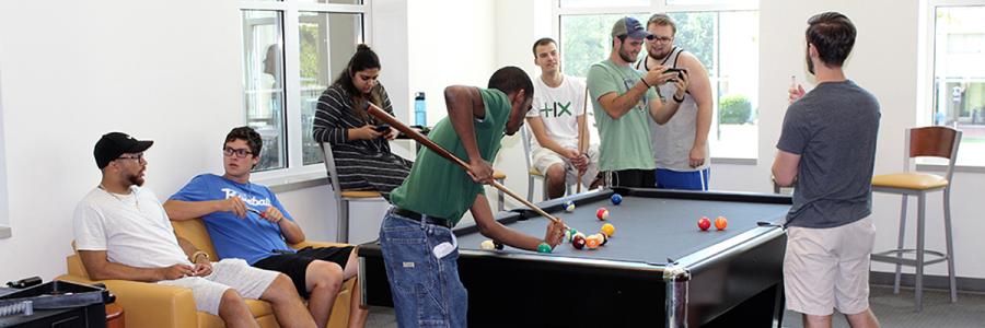 Group of students in the lounge playing pool