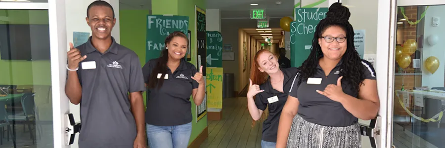 Students in the hallway doing the niner handshake