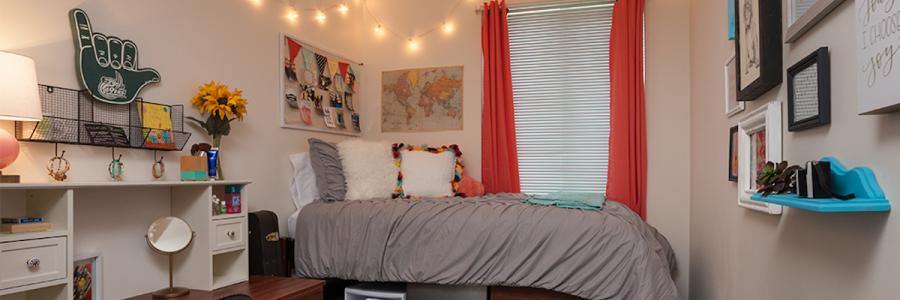 A decorated single bed dorm room