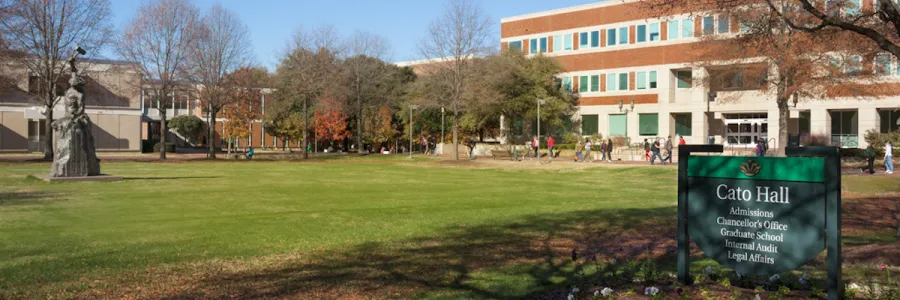 Students walking outside of Cato Hall admissions, Chancellor's Office, Graduate School, Internal Audit, and Legal Affairs