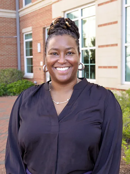 Nequell Burwell standing outside and smiling