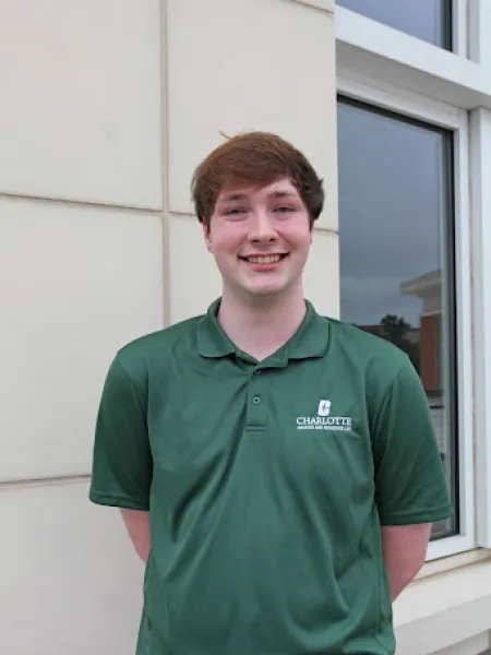 Maddox Morrow smiling in a green polo