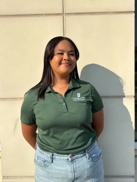 Alexis Louise Montemayor smiling outside in a green polo