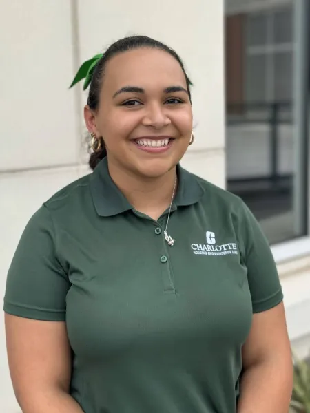 Chelsea Sisk smiling outside with a green polo