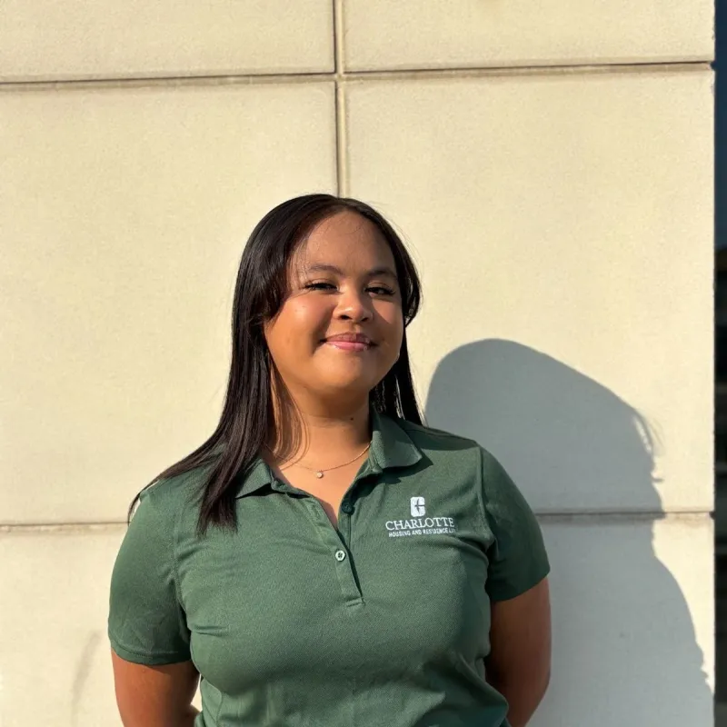 Alexis Louise Montemayor smiling outside in a green polo